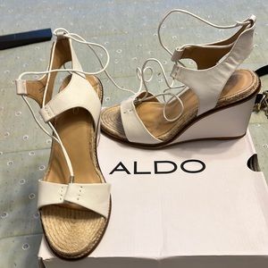 Women’s white lace up sandals, made by Aldo great bye